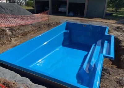 Shell of DIY fibreglass swimming pools being installed in a southern based Sydney Suburb Cosmo 6 design- colour crystal Sapphire